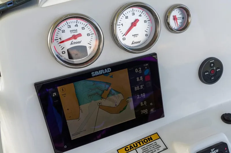 Slide: The Image of Dashboard of 2026 NauticStar 231 Hybrid with Simrad navigation display and gauges. - 4