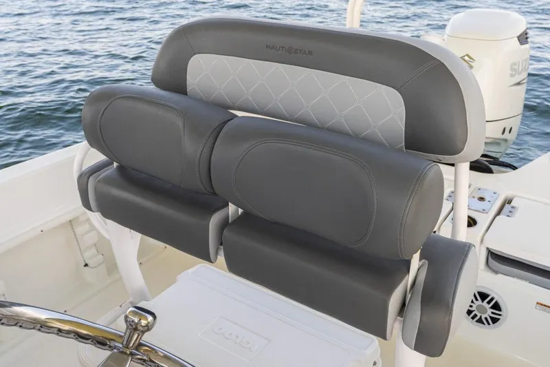 Slide: The Image of 2026 NauticStar 231 Hybrid boat seat with gray upholstery on open water. - 8