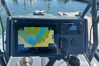 Slide: The Image of Highfield Sport 560 (2025) boat dashboard with navigation display and controls. - 13