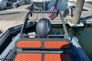 Slide: The Image of Highfield Sport 560 boat, 2025 model, docked with orange seating and American flag. - 14