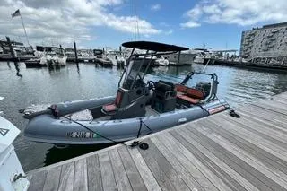 Slide: The Image of 2025 Highfield Sport 560 boat on calm water with American flag, surrounded by other boats. - 3