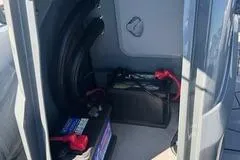 Slide: The Image of 2025 Highfield Sport 560 boat docked at marina with other vessels in background. - 8