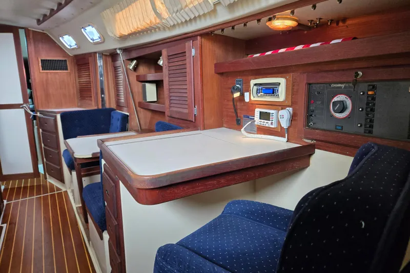 Slide: The Image of Interior of 1989 Catalina 36 sailboat with wood paneling and blue seating. - 14