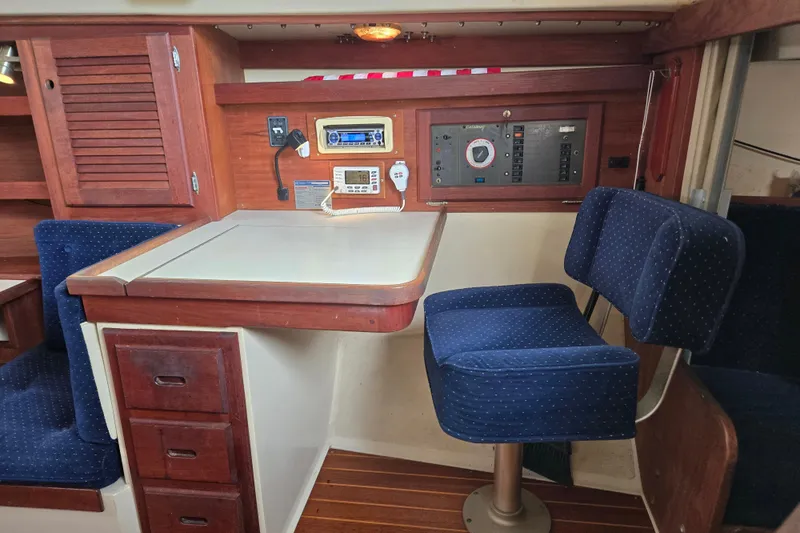 Slide: The Image of Interior of a 1989 Catalina 36 sailboat with navigation station and blue swivel chair. - 15