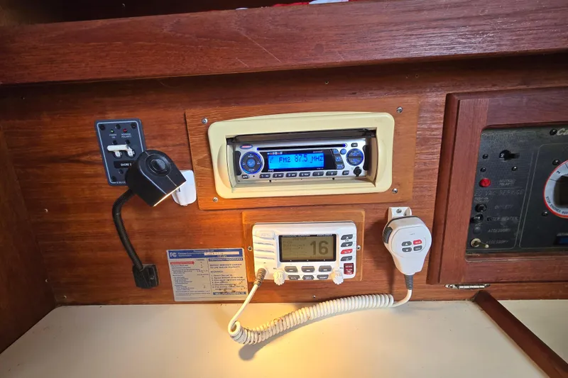 Slide: The Image of Control panel of a 1989 Catalina 36 sailboat with radio and communication equipment. - 17