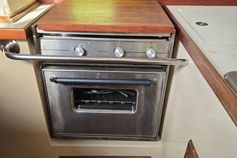 Slide: The Image of Stainless steel oven in 1989 Catalina 36 yacht kitchen with wooden countertop. - 19