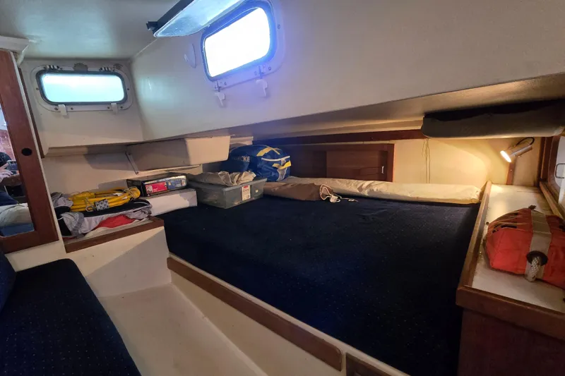 Slide: The Image of Interior cabin of a 1989 Catalina 36 sailboat with storage and bedding. - 29