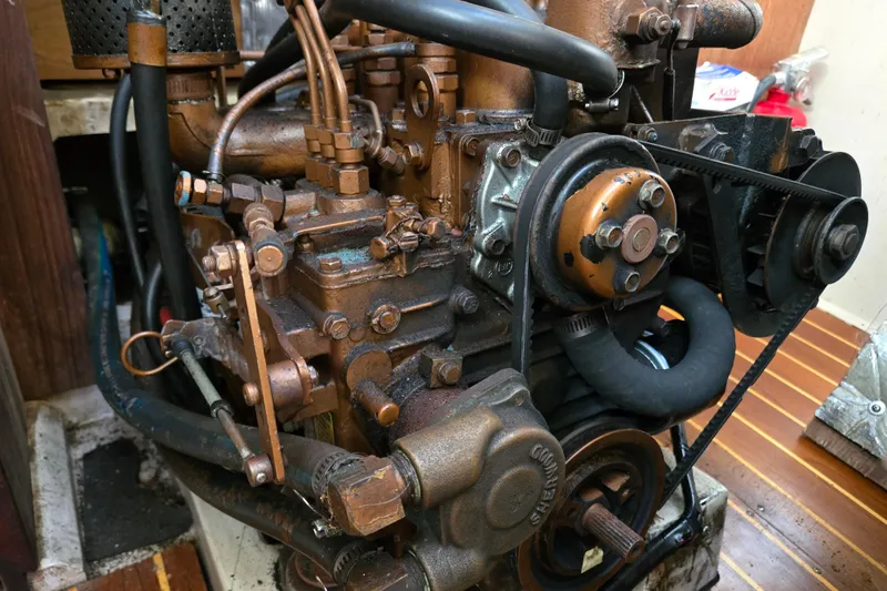 Slide: The Image of Engine of a 1989 Catalina 36 sailboat, showcasing mechanical components and belts. - 31
