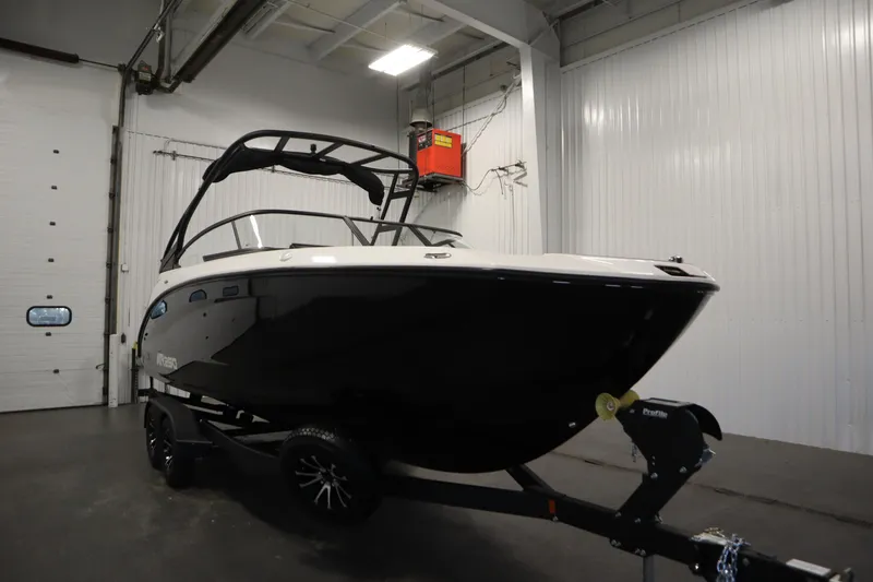 Slide: The Image of 2026 Yamaha AR250 boat in a garage, black hull, on a trailer. - 2