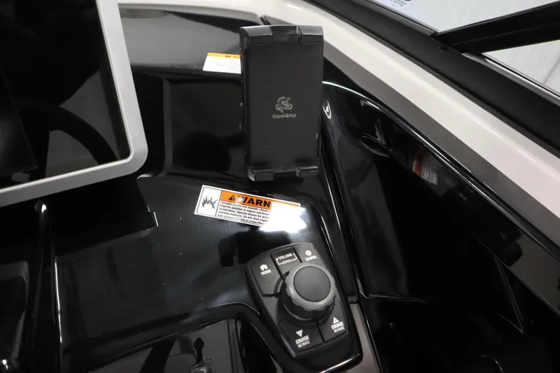 Slide: The Image of 2026 Yamaha AR250 boat dashboard with control panel and phone holder. - 20