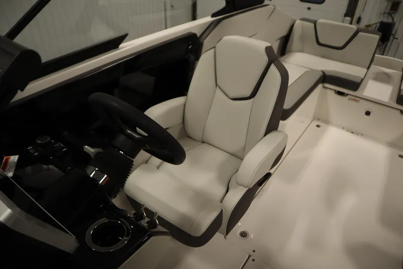 Slide: The Image of 2026 Yamaha Boats AR250 interior with sleek white seating and modern steering console. - 23