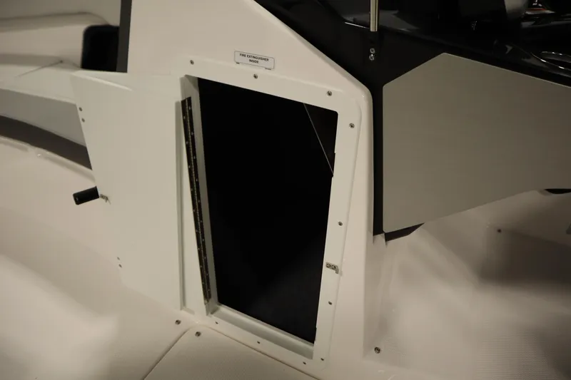 Slide: The Image of 2026 Yamaha Boats AR250 storage compartment with open door, revealing interior space. - 30