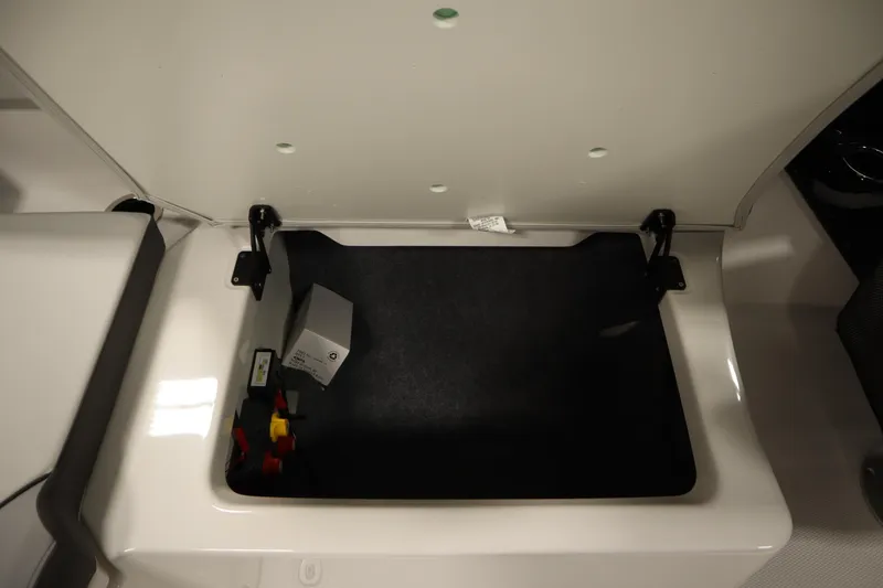 Slide: The Image of Open storage compartment in 2026 Yamaha Boats AR250, showcasing interior space and components. - 34