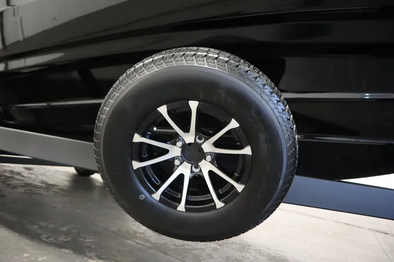 Slide: The Image of 2026 Yamaha Boats AR250 trailer wheel with sleek black and silver design. - 45