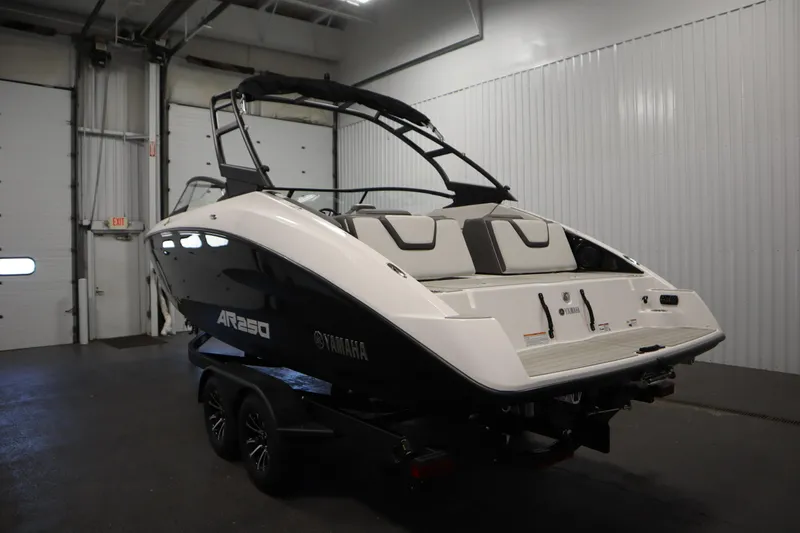 Slide: The Image of 2026 Yamaha AR250 boat in a garage, showcasing sleek design and modern features. - 6