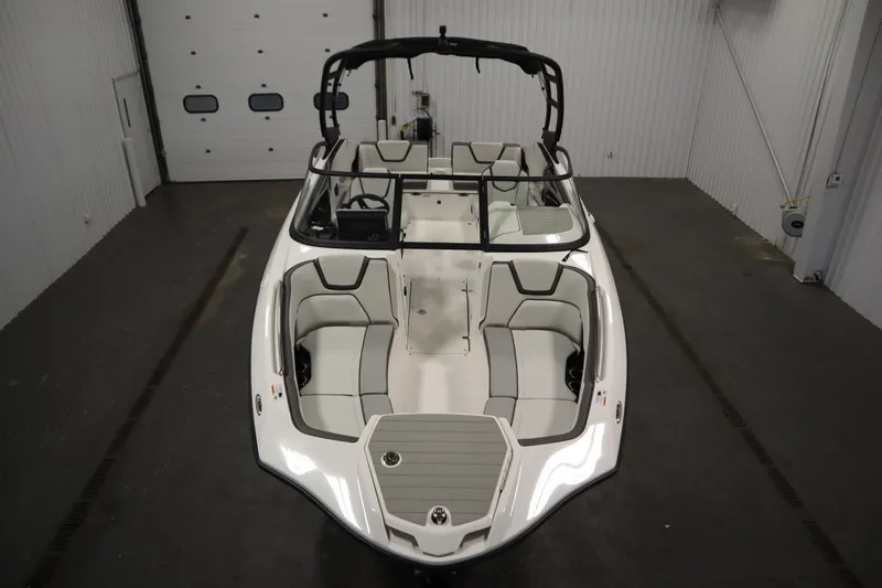 Slide: The Image of 2026 Yamaha Boats AR250 in a garage, showcasing sleek design and spacious seating. - 8