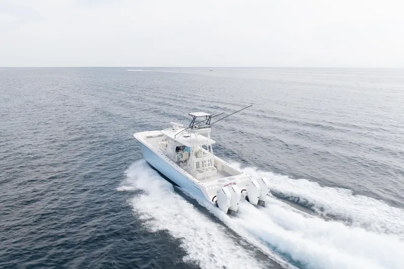 Slide: The Image of 2022 Invincible 46 Catamaran cruising on open sea, showcasing powerful engines and sleek design. - 10