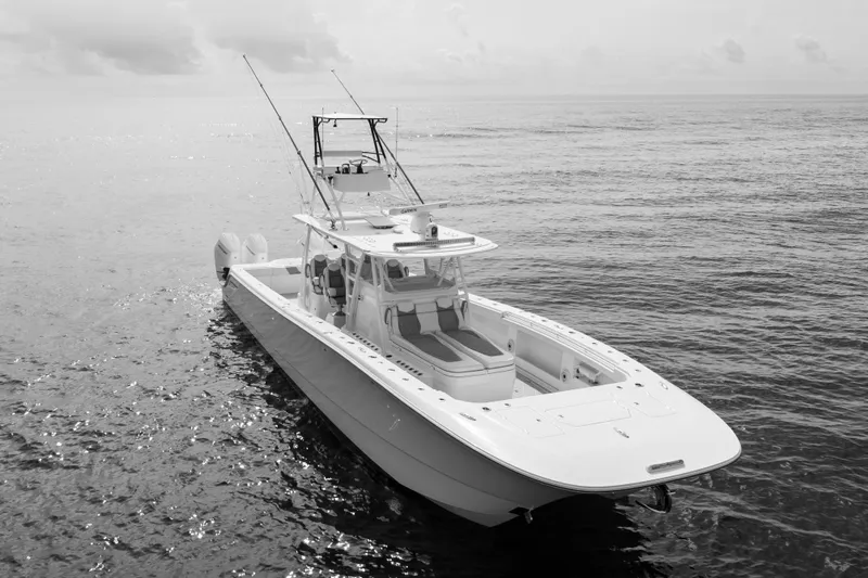 Slide: The Image of 2022 Invincible 46 Catamaran on calm ocean waters, showcasing sleek design and fishing equipment. - 15