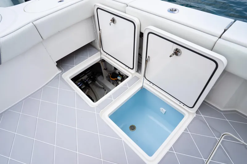 Slide: The Image of Open storage compartments on 2022 Invincible 46 Catamaran deck, showcasing interior features. - 16
