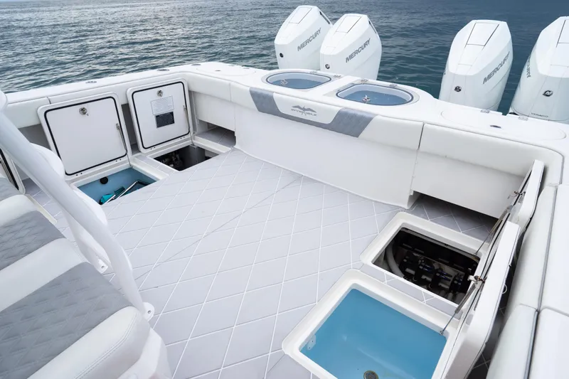 Slide: The Image of 2022 Invincible 46 Catamaran deck with storage compartments and Mercury engines. - 17