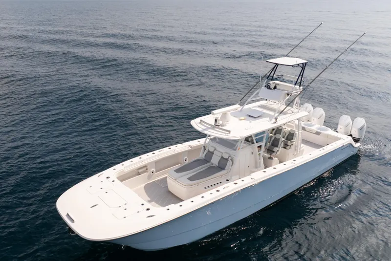 Slide: The Image of 2022 Invincible 46 Catamaran cruising on open sea, showcasing sleek design and powerful engines. - 2