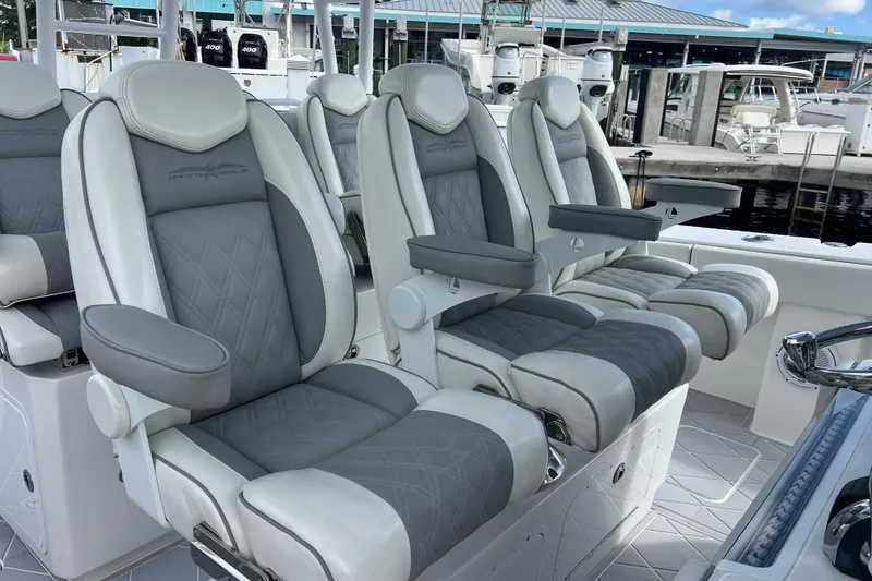 Slide: The Image of Luxurious seating on 2022 Invincible 46 Catamaran, featuring plush gray and white upholstery. - 21