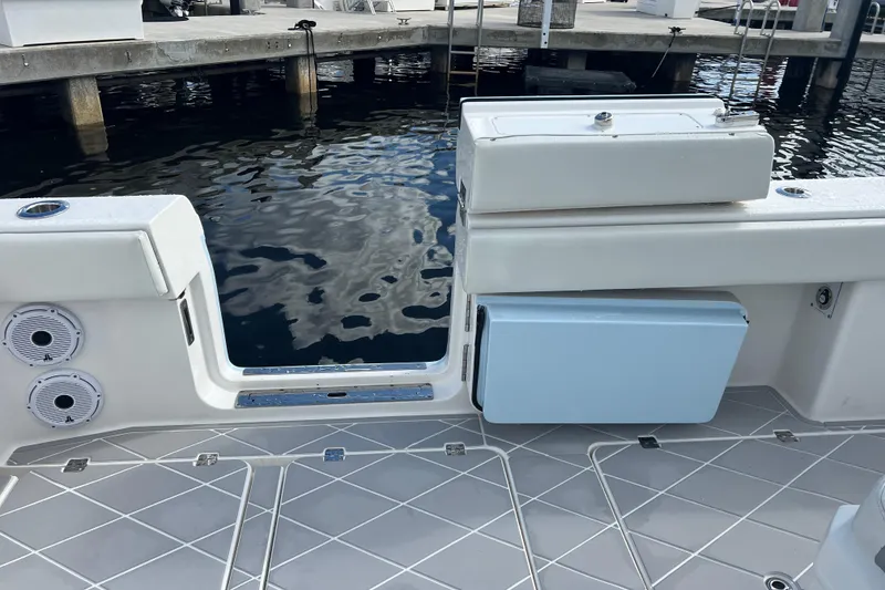 Slide: The Image of 2022 Invincible 46 Catamaran deck with speakers and storage, dockside view. - 30