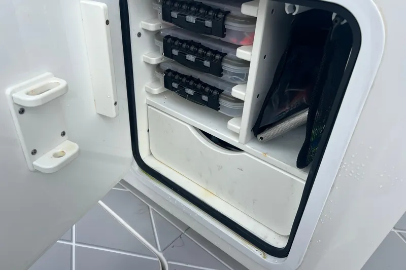 Slide: The Image of Storage compartment on a 2022 Invincible 46 Catamaran, featuring organized tackle boxes. - 33