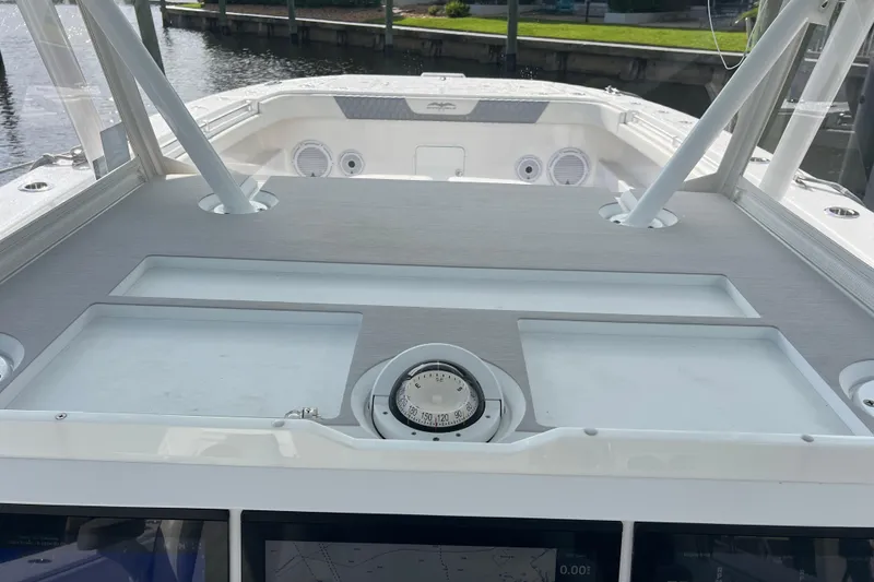 Slide: The Image of 2022 Invincible 46 Catamaran helm with compass and navigation equipment. - 37