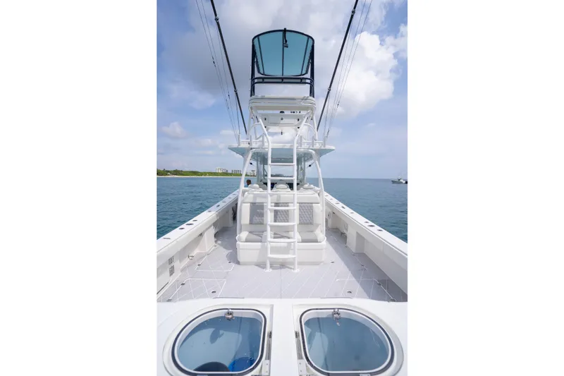 Slide: The Image of 2022 Invincible 46 Catamaran on open water, featuring spacious deck and modern design. - 40