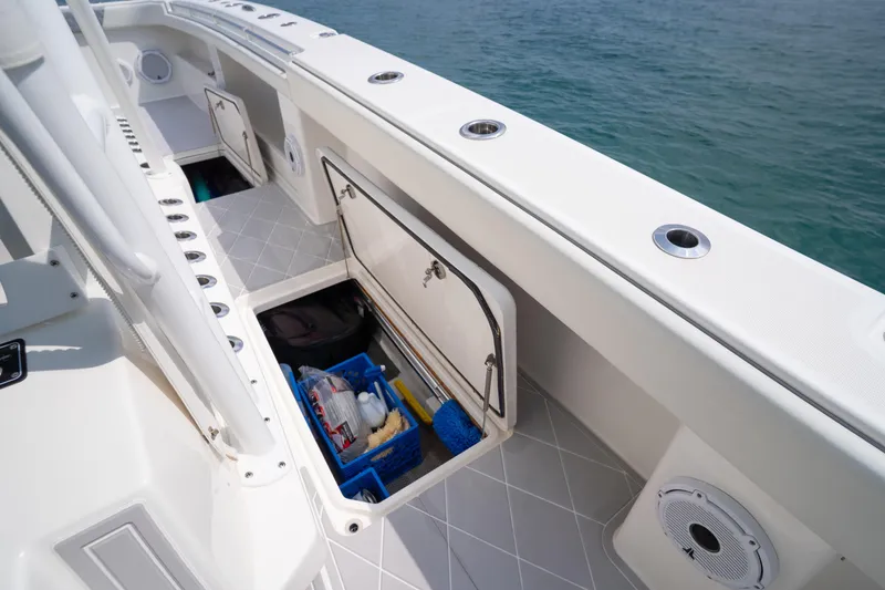 Slide: The Image of 2022 Invincible 46 Catamaran storage compartment with ocean view, showcasing organized equipment. - 42