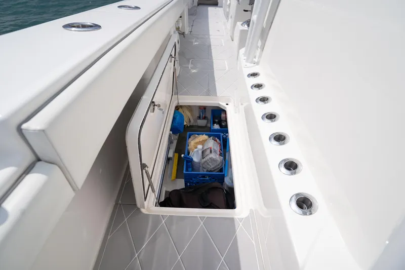 Slide: The Image of Storage compartment on 2022 Invincible 46 Catamaran, featuring organized fishing gear and accessories. - 47