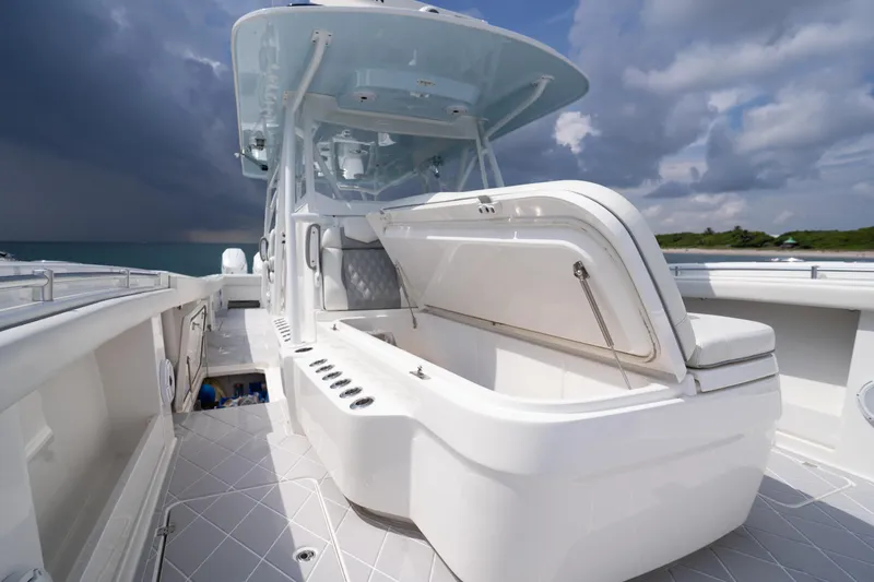 Slide: The Image of 2022 Invincible 46 Catamaran with open storage, sleek design, and ocean backdrop. - 49