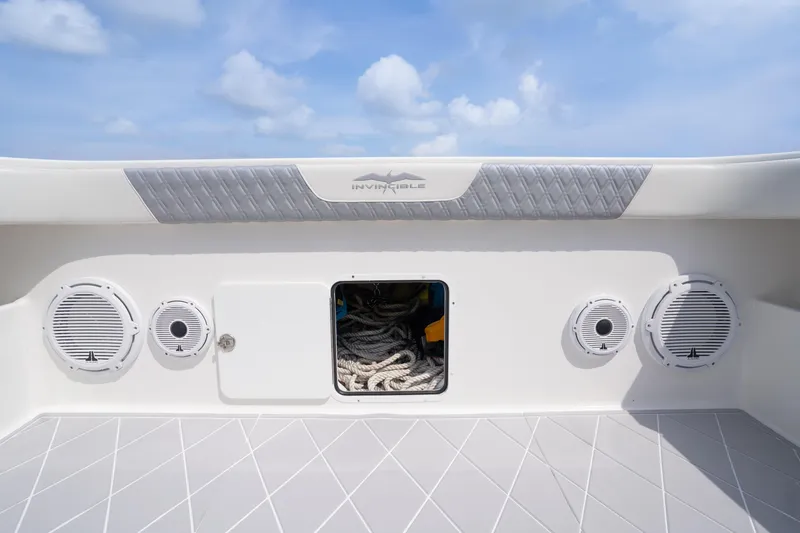 Slide: The Image of 2022 Invincible 46 Catamaran deck with storage and speakers under a clear sky. - 54