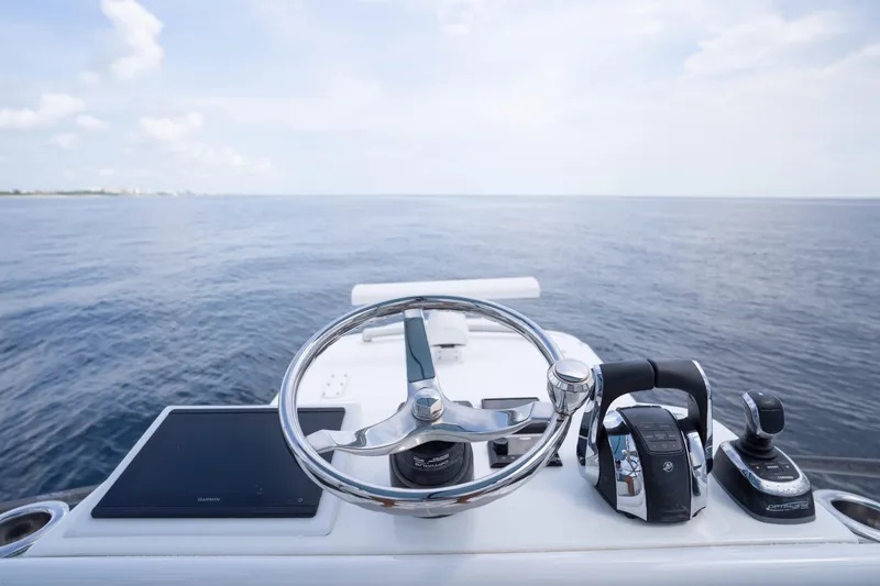 Slide: The Image of Helm of 2022 Invincible 46 Catamaran with ocean view, featuring modern controls and steering. - 56