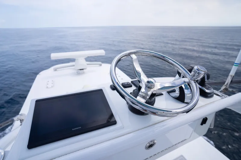 Slide: The Image of Helm of 2022 Invincible 46 Catamaran with ocean view and navigation equipment. - 58