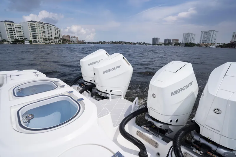 Slide: The Image of Invincible 46 Catamaran 2022 with Mercury engines on a scenic waterfront. - 59