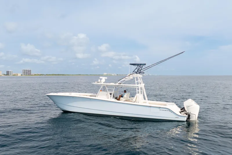 Slide: The Image of 2022 Invincible 46 Catamaran on open water, showcasing sleek design and powerful engines. - 6