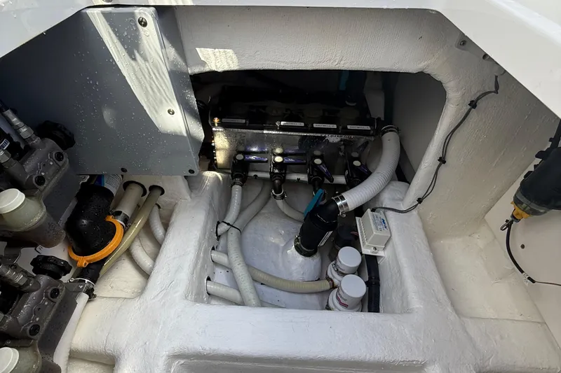 Slide: The Image of Engine compartment of 2022 Invincible 46 Catamaran, showcasing hoses and mechanical components. - 64