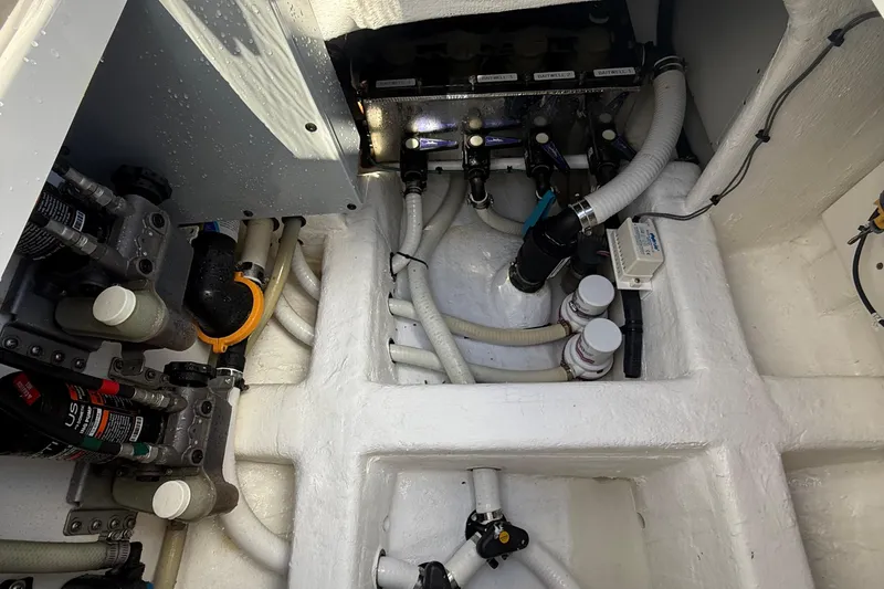 Slide: The Image of Engine room of 2022 Invincible 46 Catamaran with visible pipes and components. - 65