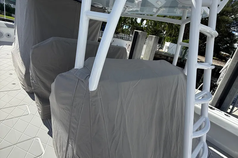 Slide: The Image of 2022 Invincible 46 Catamaran with covered seating and ladder, docked in a marina. - 70