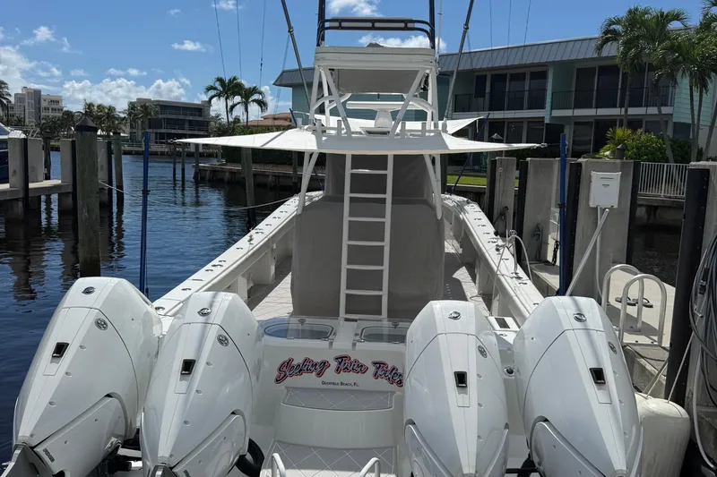 Slide: The Image of 2022 Invincible 46 Catamaran docked, featuring four powerful outboard engines. - 74