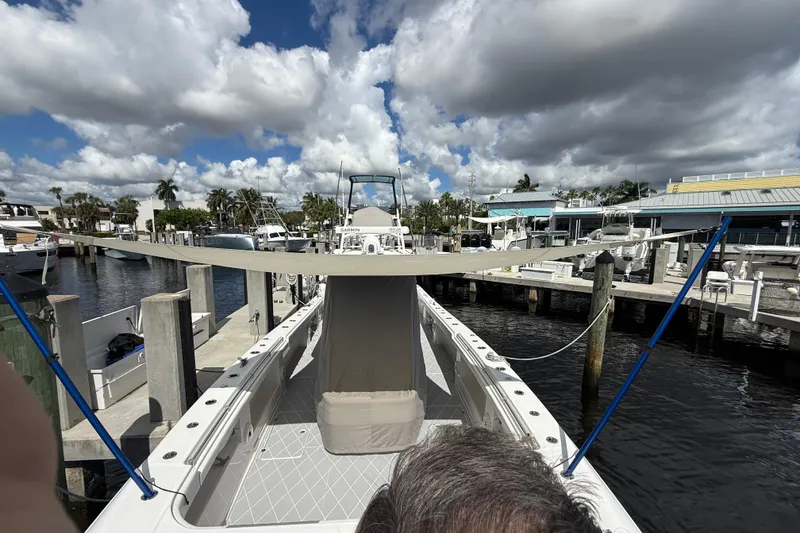 Slide: The Image of 2022 Invincible 46 Catamaran docked at marina under cloudy sky. - 76