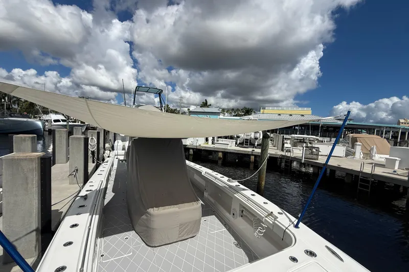Slide: The Image of 2022 Invincible 46 Catamaran docked with sunshade under cloudy sky. - 78