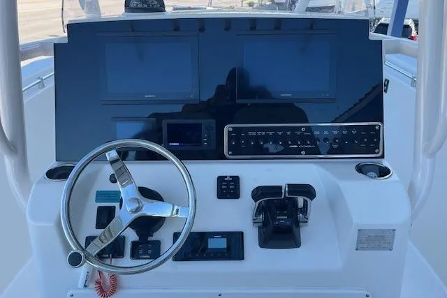 Slide: The Image of 2018 Cobia 277 Center Console dashboard with steering wheel and electronic controls. - 3