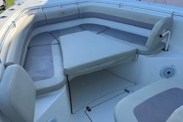 Slide: The Image of 2018 Cobia 277 Center Console boat with cushioned seating and table in the bow area. - 4