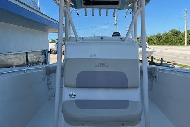 Slide: The Image of 2018 Cobia 277 Center Console boat interior with seating and console view. - 5
