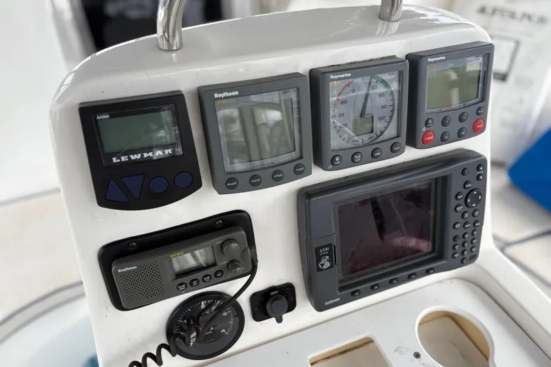 Slide: The Image of Control panel of a 2002 Hunter 386 sailboat with navigation instruments and displays. - 11