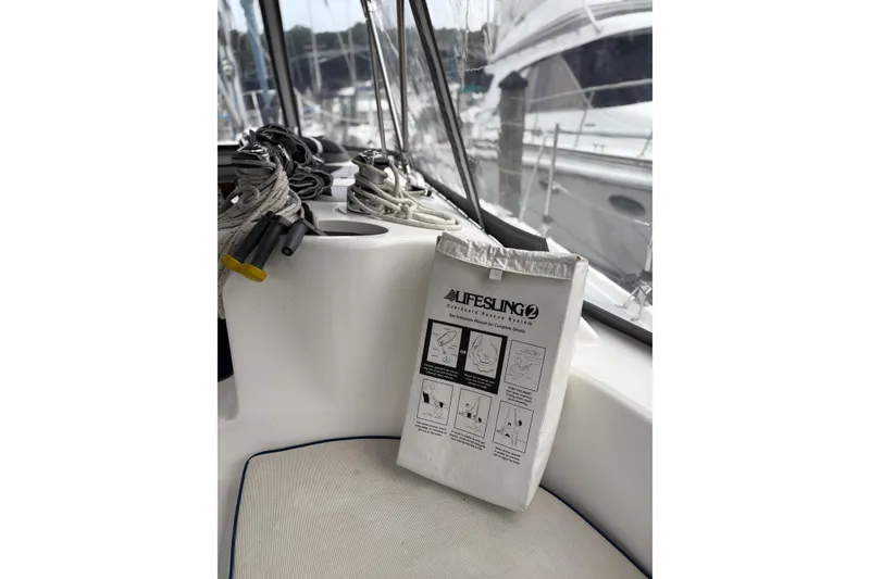Slide: The Image of Lifesling rescue system on 2002 Hunter 386 sailboat, docked with coiled ropes. - 13