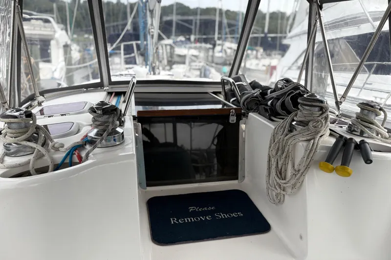 Slide: The Image of Cockpit of 2002 Hunter 386 sailboat with ropes and "Please Remove Shoes" mat. - 14